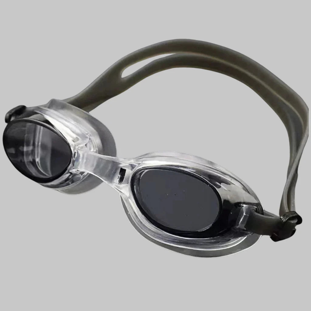 Swimming goggles with black lenses and gray straps on a light gray background