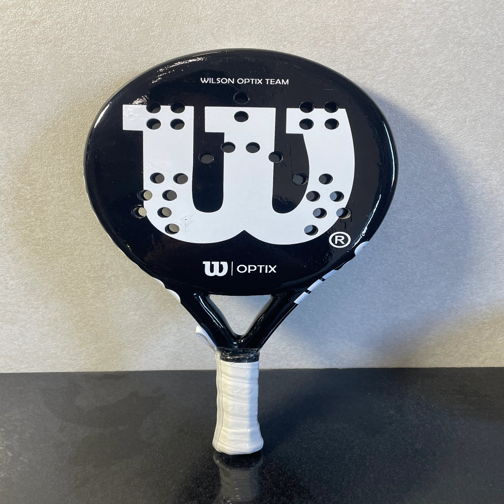 Black Wilson Optix Team tennis racket on a gray background