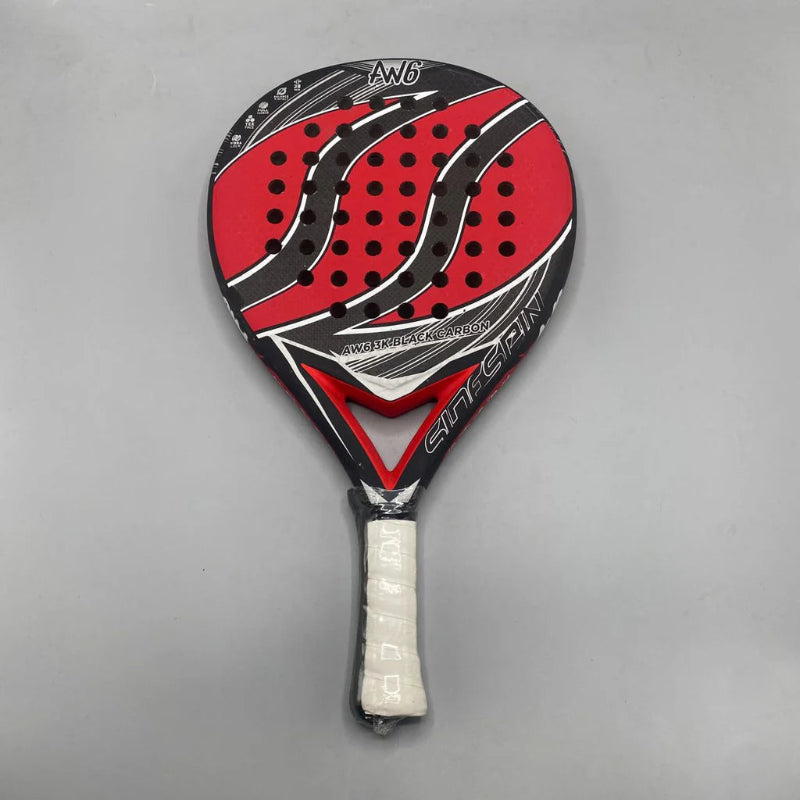 Red and black tennis racket with white handle on a gray background