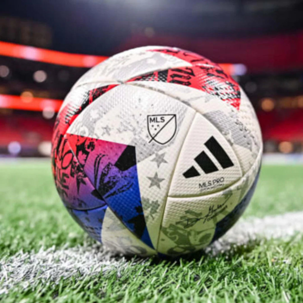 Colorful soccer ball with MLS and Adidas logos on a grass field