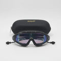 Black swim goggles with protective film on a white background, featuring Speedo branding.