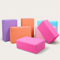 Set of colorful yoga blocks on a light gray background