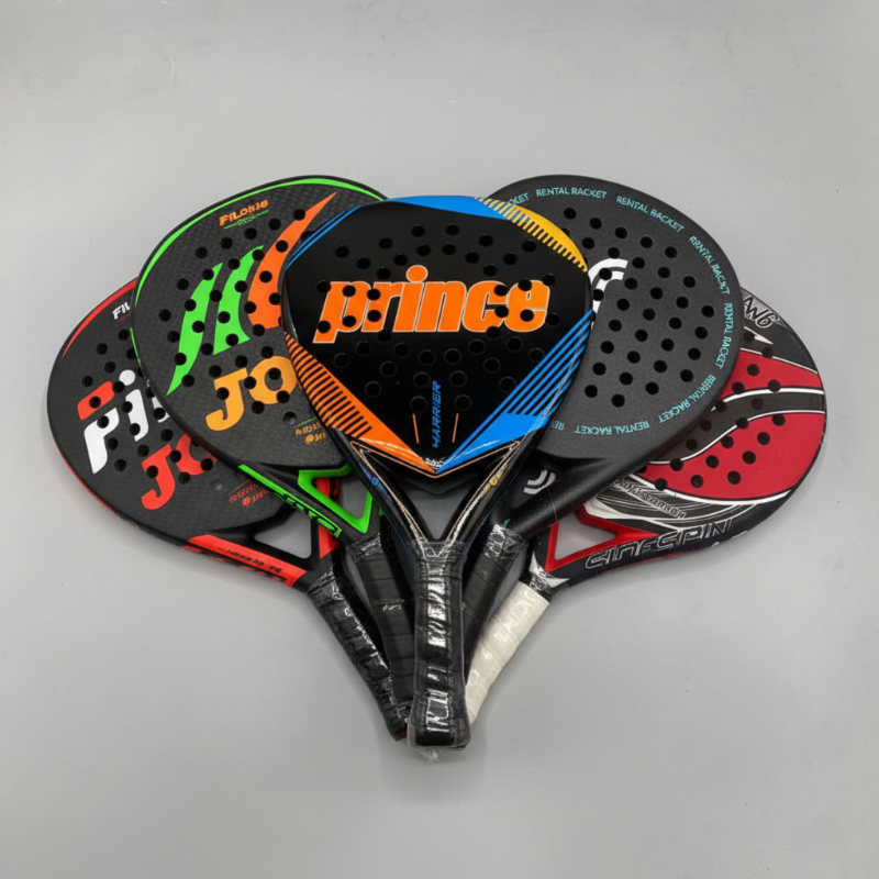 Collection of Prince paddle rackets on a gray background